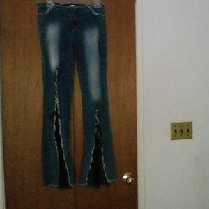 Tight bell bottom jeans. The bell part is fishnet.